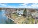 Stunning waterfront home boasts lush landscaping and a private dock with lake access and serene views at 1852 Lakeside Ln, Indianapolis, IN 46229