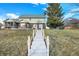 View of the back of the house showing a brick exterior, screened-in porch, and stairs to the water at 1852 Lakeside Ln, Indianapolis, IN 46229