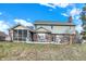 View of the back of the house showing a screened-in porch and brick and vinyl siding at 1852 Lakeside Ln, Indianapolis, IN 46229