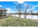 View of the back yard from the house to the water, including trees and landscaping at 1852 Lakeside Ln, Indianapolis, IN 46229