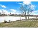 View of the backyard with stairs down to the water, some trees, and surrounding houses at 1852 Lakeside Ln, Indianapolis, IN 46229
