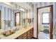 Stylized bathroom with striped wallpaper, and oak vanity at 1852 Lakeside Ln, Indianapolis, IN 46229