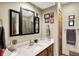 Bathroom with a white countertop vanity, black framed mirrors and neutral walls at 1852 Lakeside Ln, Indianapolis, IN 46229