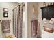 Bathroom with a shower and decorative shelves stocked with towels and baskets at 1852 Lakeside Ln, Indianapolis, IN 46229