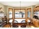 Bright dining room with a large window, hardwood floors, and ample seating for Gathering at 1852 Lakeside Ln, Indianapolis, IN 46229