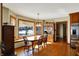 Cozy dining room with hardwood floors, large window, and stainless steel refrigerator at 1852 Lakeside Ln, Indianapolis, IN 46229