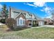 Two-story home featuring brick accents, a well-maintained lawn, and mature trees at 1852 Lakeside Ln, Indianapolis, IN 46229