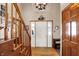 Inviting foyer with hardwood floors, staircase, and decorative chandelier at 1852 Lakeside Ln, Indianapolis, IN 46229