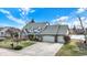 Attractive two-story home with a brick and siding exterior, a three-car garage, and beautiful landscaping at 1852 Lakeside Ln, Indianapolis, IN 46229