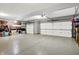 Well-lit two car garage with epoxy floor, garage door openers and ample storage shelving at 1852 Lakeside Ln, Indianapolis, IN 46229