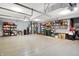 Spacious three car garage with epoxy floor, featuring ample storage shelving at 1852 Lakeside Ln, Indianapolis, IN 46229
