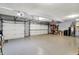 Well-lit two car garage with epoxy floor, garage door openers and ample storage shelving at 1852 Lakeside Ln, Indianapolis, IN 46229