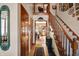Hallway with hardwood floors, staircase, and views into the living room at 1852 Lakeside Ln, Indianapolis, IN 46229