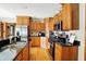 Modern kitchen with stainless steel appliances, granite countertops, and hardwood floors at 1852 Lakeside Ln, Indianapolis, IN 46229