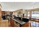 Open-concept kitchen featuring dark countertops and connection to the living room with a fireplace at 1852 Lakeside Ln, Indianapolis, IN 46229