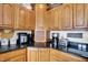 Kitchen details showcasing wooden cabinets and granite countertops plus modern appliances at 1852 Lakeside Ln, Indianapolis, IN 46229