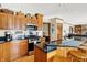 Modern kitchen with stainless steel appliances, granite countertops, and wooden cabinets at 1852 Lakeside Ln, Indianapolis, IN 46229