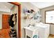 Functional laundry room with sink and washer/dryer adjacent to a mudroom with closet at 1852 Lakeside Ln, Indianapolis, IN 46229