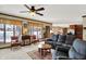 Inviting living room with a ceiling fan, plush seating, and natural light from the windows at 1852 Lakeside Ln, Indianapolis, IN 46229
