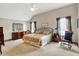 Spacious main bedroom with a ceiling fan, neutral walls, and abundant natural light at 1852 Lakeside Ln, Indianapolis, IN 46229
