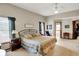 Bright main bedroom featuring plush carpet, neutral walls and ceiling fan at 1852 Lakeside Ln, Indianapolis, IN 46229