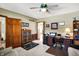 Home office with built-in desk and shelving, a ceiling fan and carpet flooring at 1852 Lakeside Ln, Indianapolis, IN 46229