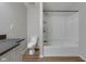 This bathroom features a toilet, bathtub with shower, vanity with gray countertop, and gray walls at 2014 Barth Ave, Indianapolis, IN 46203