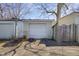 This is a detached garage with a light colored siding and a white garage door at 2014 Barth Ave, Indianapolis, IN 46203