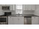 Modern kitchen featuring stainless steel appliances, white cabinets, and dark countertops at 2014 Barth Ave, Indianapolis, IN 46203