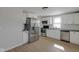 Renovated kitchen featuring stainless steel appliances, white cabinetry, and new flooring at 2014 Barth Ave, Indianapolis, IN 46203