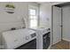 This laundry room features a washer, dryer, window, and laundry room decor at 2014 Barth Ave, Indianapolis, IN 46203