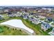 Aerial shot of a neighborhood showcasing beautiful homes nestled around a snow-covered pond at 20451 Chatham Hills Blvd, Westfield, IN 46074