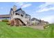 Lovely two-story home featuring a lush green backyard, a spacious deck, and a charming stone retaining wall at 20451 Chatham Hills Blvd, Westfield, IN 46074