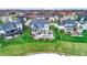 Aerial view of a home's backyard featuring lush lawn, patio with fire pit, and hot tub at 20451 Chatham Hills Blvd, Westfield, IN 46074