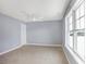 Bedroom featuring a large window, carpeted floors, and a door for easy access at 20451 Chatham Hills Blvd, Westfield, IN 46074