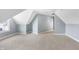 Spacious attic bedroom featuring carpeted floors, a ceiling fan, and a window with neighborhood views at 20451 Chatham Hills Blvd, Westfield, IN 46074