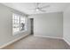 This bedroom features neutral decor, a large window, and a closet for ample storage at 20451 Chatham Hills Blvd, Westfield, IN 46074