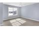 Bright bedroom featuring soft carpet, a ceiling fan, and a large window for ample natural light at 20451 Chatham Hills Blvd, Westfield, IN 46074