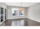 Open dining area boasts dark wood floors, modern chandelier, and sliding door to the outdoor at 20451 Chatham Hills Blvd, Westfield, IN 46074