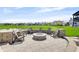 Enjoy the stunning view from this backyard firepit seating area, perfect for relaxing and entertaining at 20451 Chatham Hills Blvd, Westfield, IN 46074