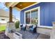 Cozy front porch seating area with stone pillars and a blue accent wall at 20451 Chatham Hills Blvd, Westfield, IN 46074