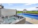 Relax in the hot tub by the refreshing backyard pool, offering a serene outdoor experience at 20451 Chatham Hills Blvd, Westfield, IN 46074