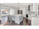 Modern kitchen with an island, stainless steel appliances, and white cabinets at 20451 Chatham Hills Blvd, Westfield, IN 46074
