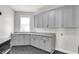 Modern laundry room featuring custom cabinets, granite countertops, and sleek fixtures at 20451 Chatham Hills Blvd, Westfield, IN 46074