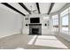 Bright living room with a stone fireplace, built-in shelves, ceiling fan, and large windows at 20451 Chatham Hills Blvd, Westfield, IN 46074