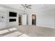 Living room featuring a stone fireplace, built-in shelving, carpet, and gray walls at 20451 Chatham Hills Blvd, Westfield, IN 46074
