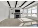 Bright living room with a stone fireplace, built-in shelves, ceiling fan, and large windows at 20451 Chatham Hills Blvd, Westfield, IN 46074