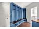 Well-organized mudroom with blue built-in lockers, bench seating, and hardwood floors at 20451 Chatham Hills Blvd, Westfield, IN 46074