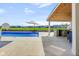 Resort-style backyard pool with a lounge area, outdoor kitchen, and lovely water views at 20451 Chatham Hills Blvd, Westfield, IN 46074