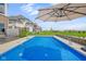 Sparkling backyard pool with hot tub, privacy wall, and beautifully landscaped surroundings at 20451 Chatham Hills Blvd, Westfield, IN 46074